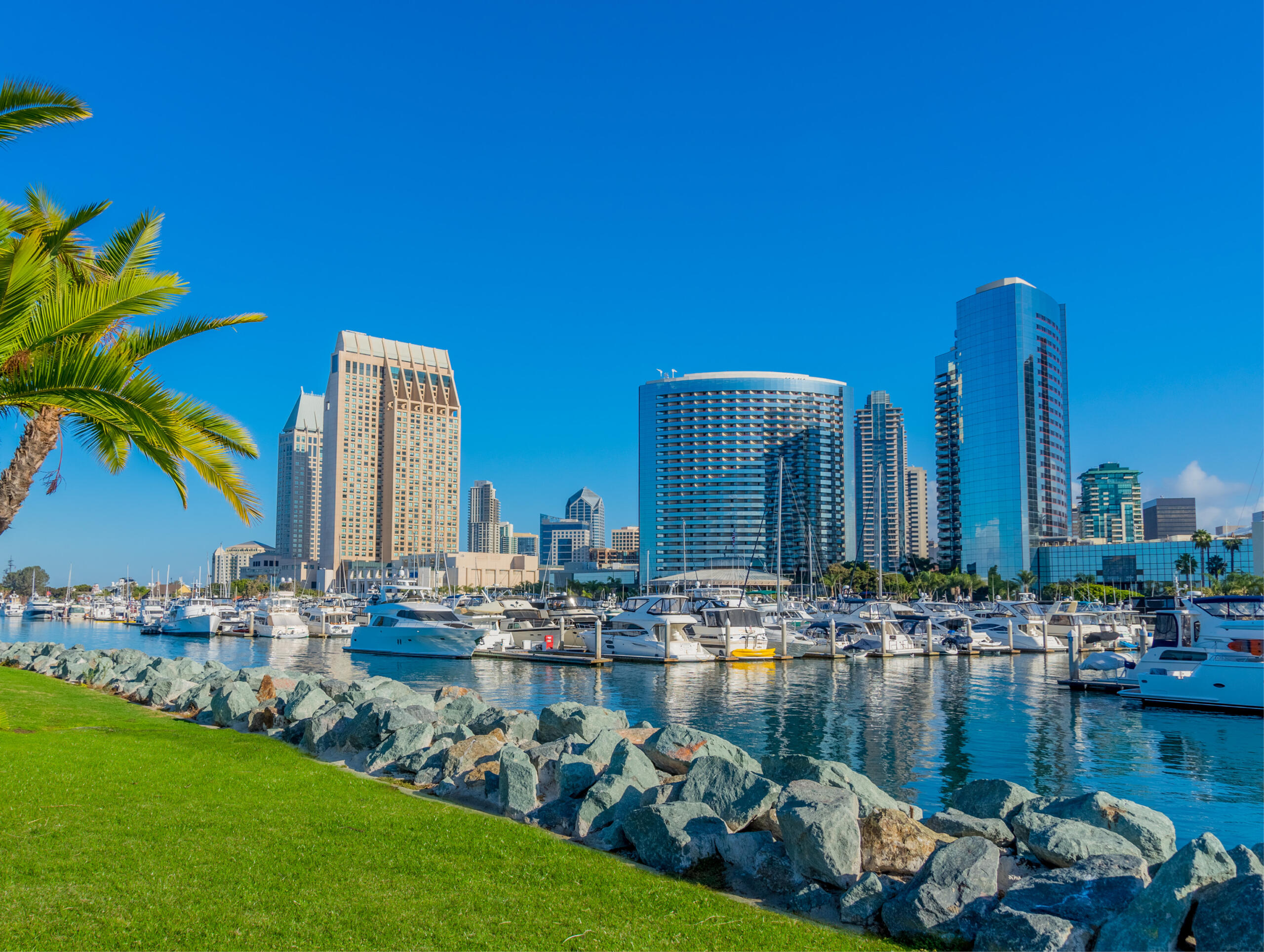 Beautiful Orange County beachside with waves crashing and homes in the background.