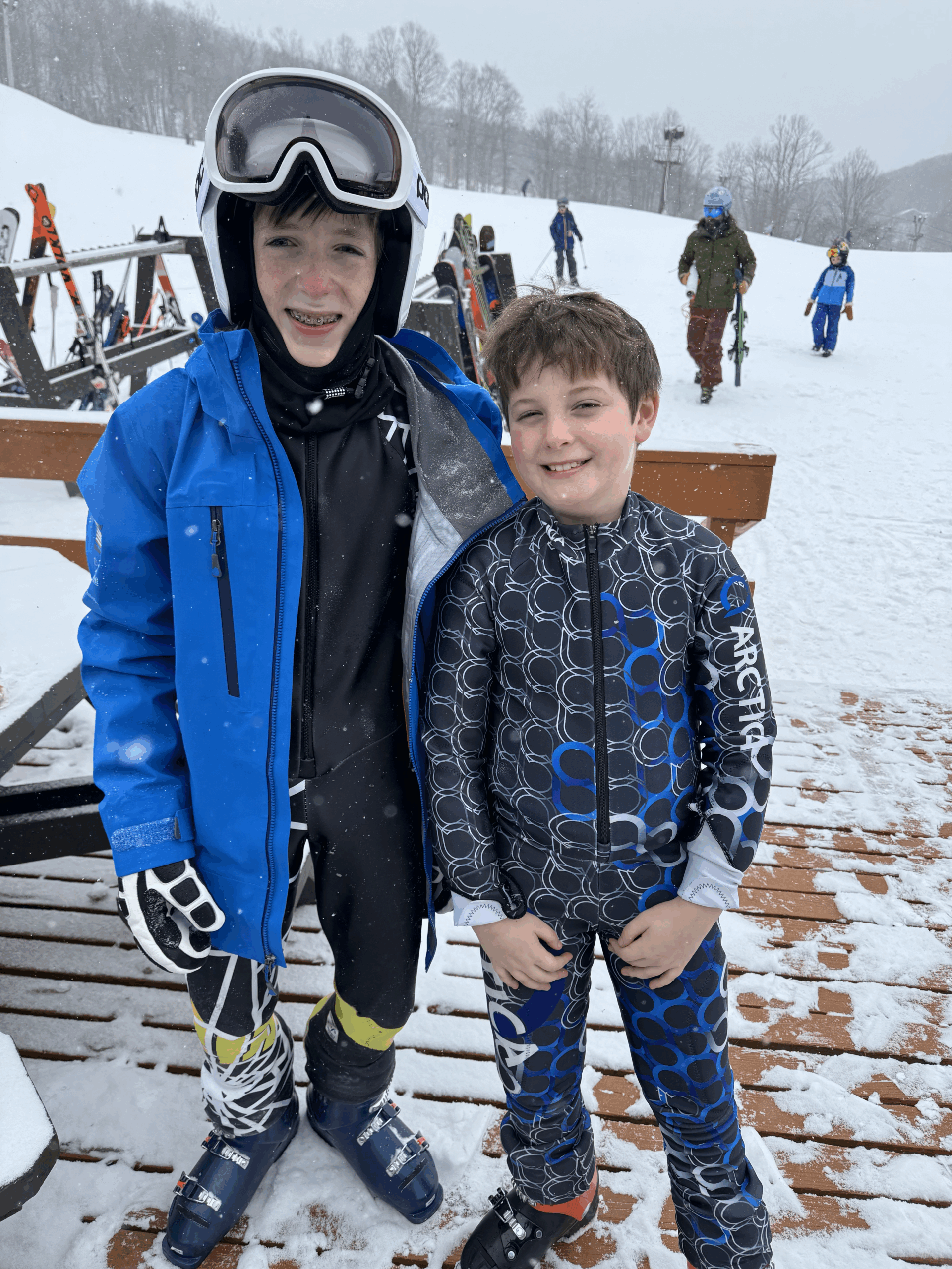 Two young boys in snowboarding gear