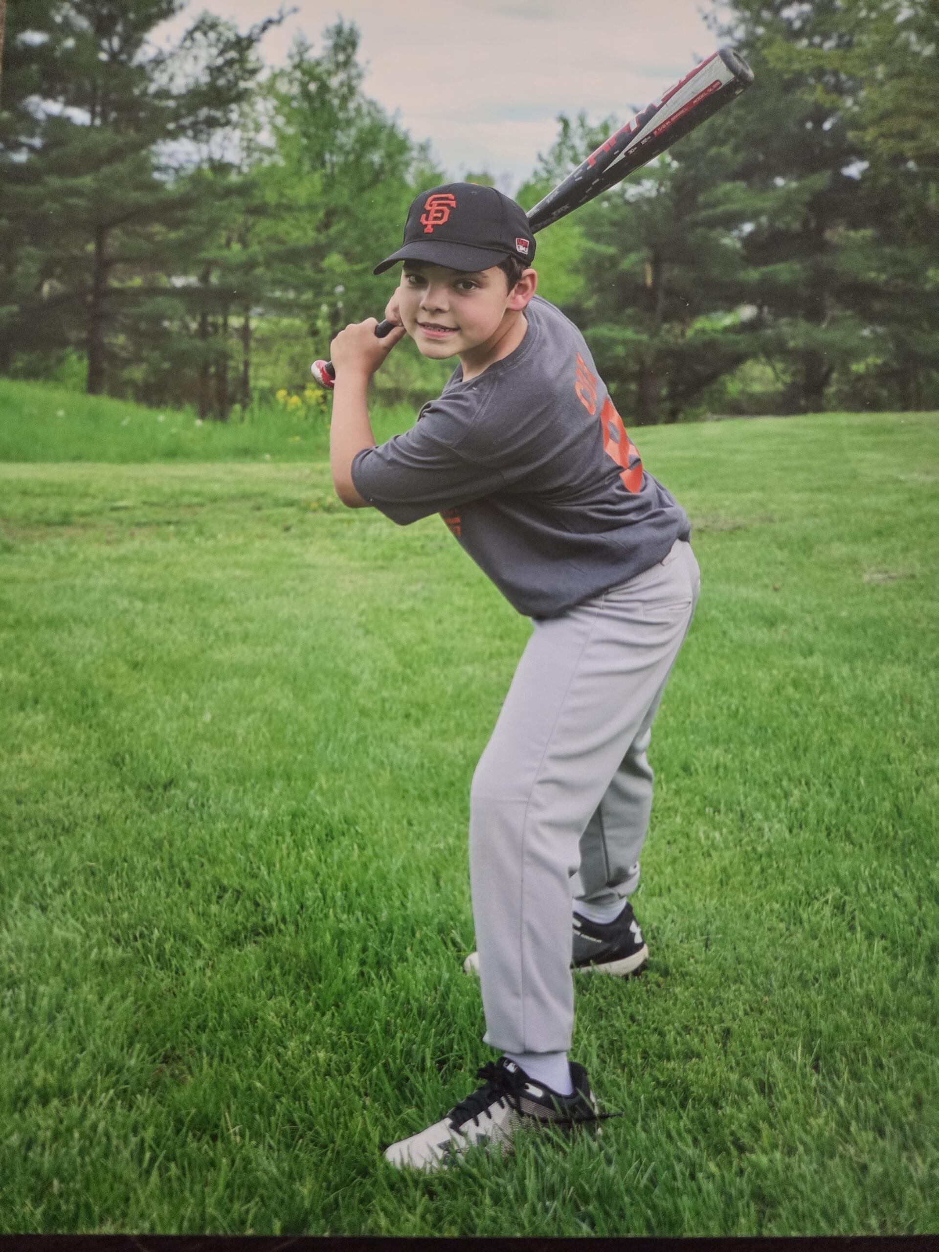Logan posing with a baseball bat