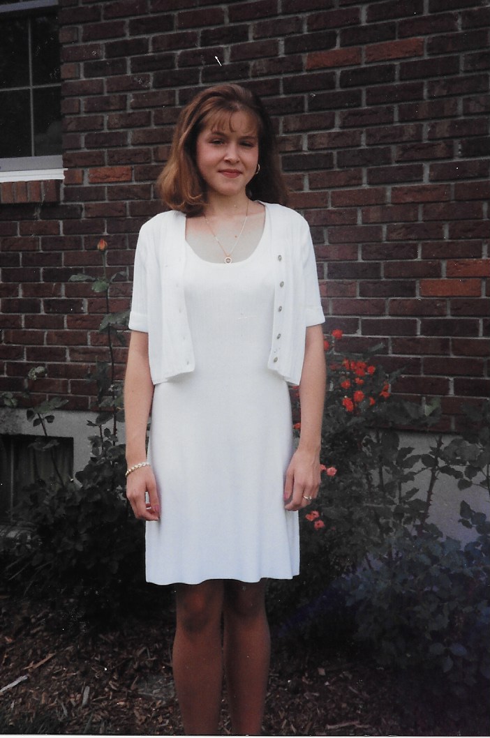 Kirsten as a young girl in a white dress