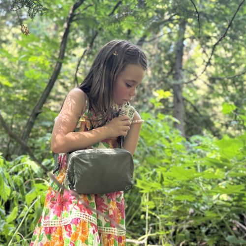 Faye drinking a juice box outside