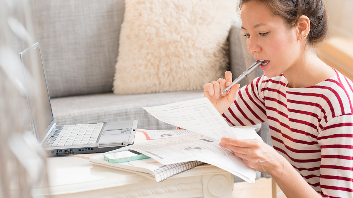 Woman Adding Up a Total Cost of How Much Type 1 Diabetes Medication Will Cost With Insurance