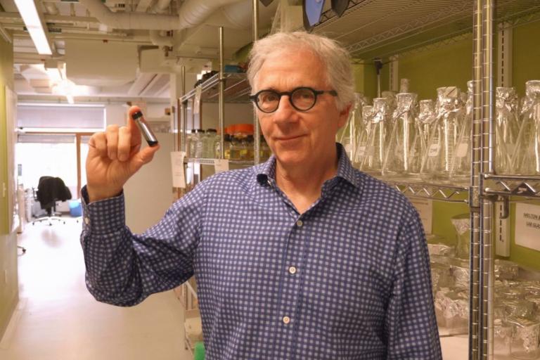 Douglas Melton, Ph.D., holds up a vial of beta cells