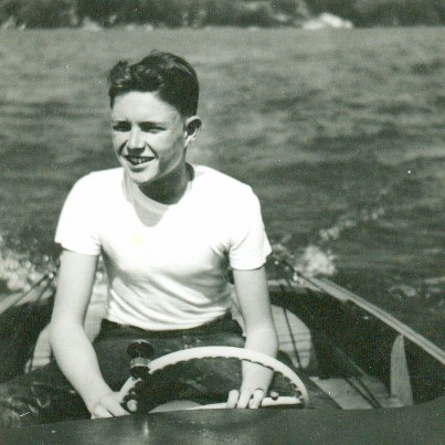 A young John McDonough on a sailboat cruising around