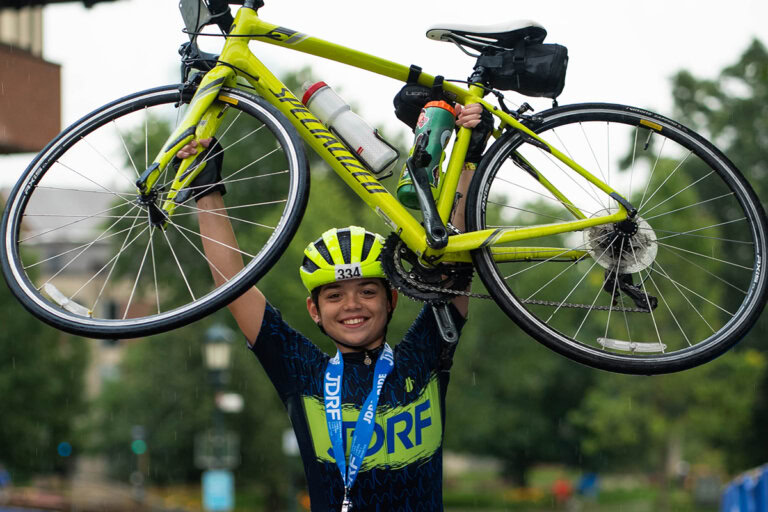 Breakthrough T1D Rider Drew Salaki at the finish line in Burlington, VT