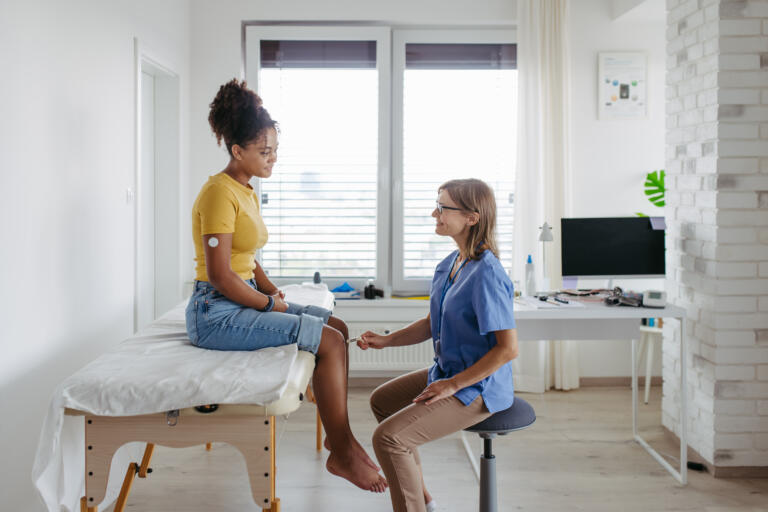 Woman and Physician Discussing Medical Affairs