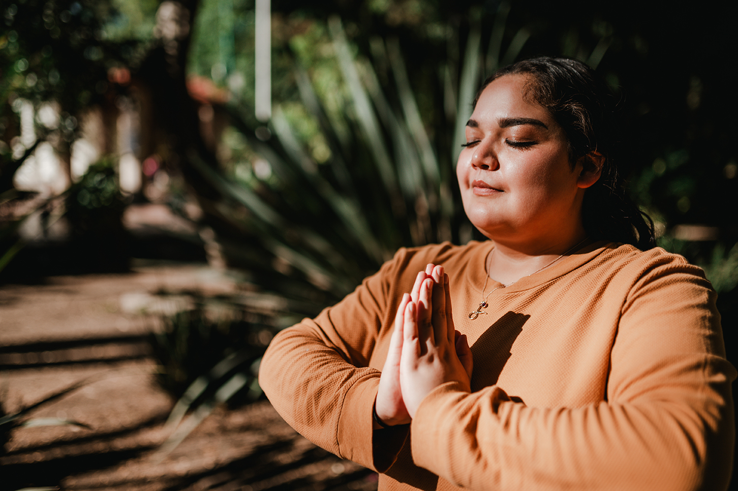 Young woman meditating outside
