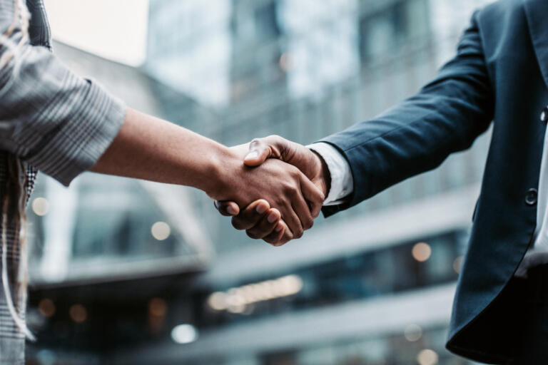 Employer and employee shake hands