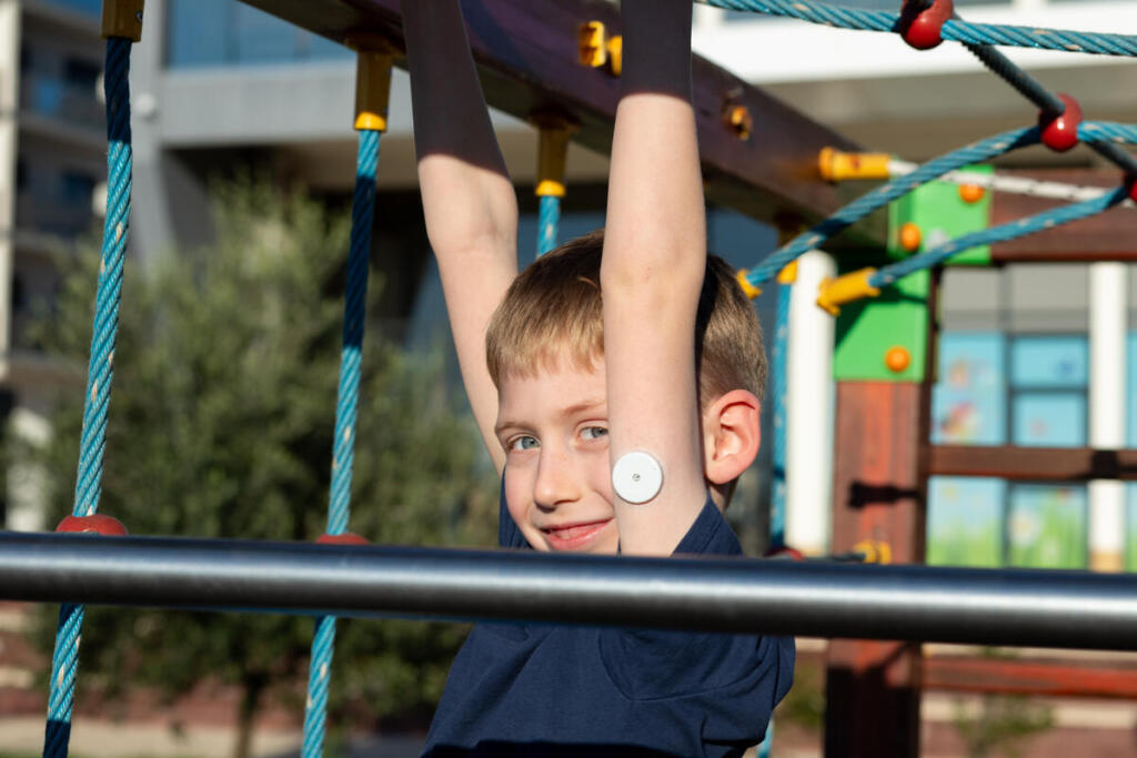 Young boy with type 1 diabetes at the school playground