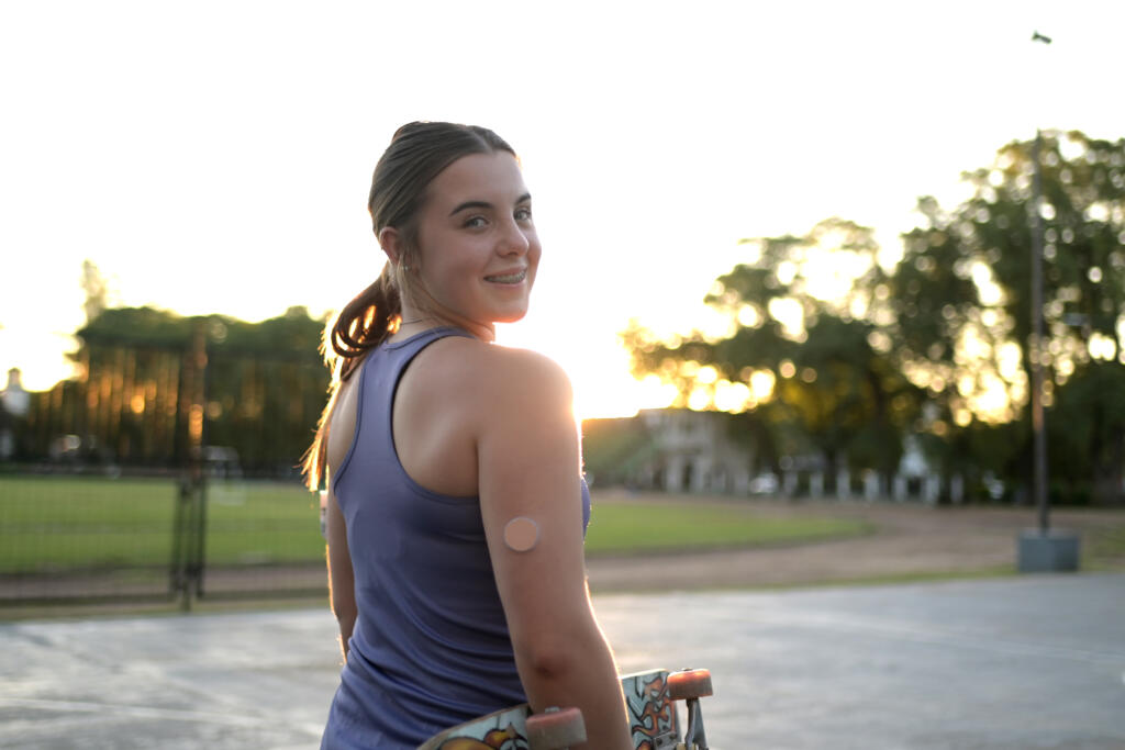 Teenaged girl with type 1 diabetes at a skate park